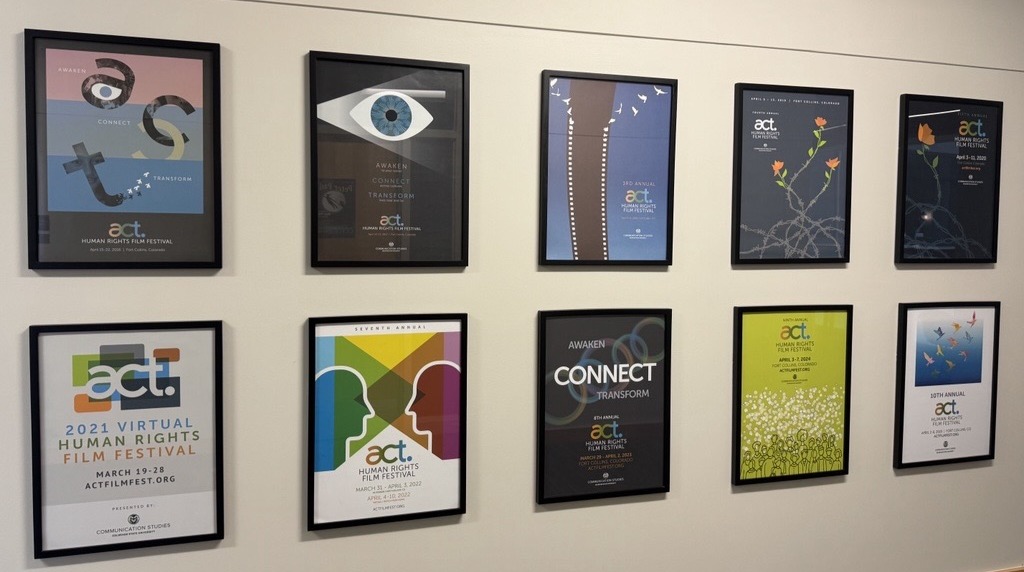 Wall with posters of past ten years of ACT Human Rights Film Festival creative design. Located in Behavioral Sciences outside A201